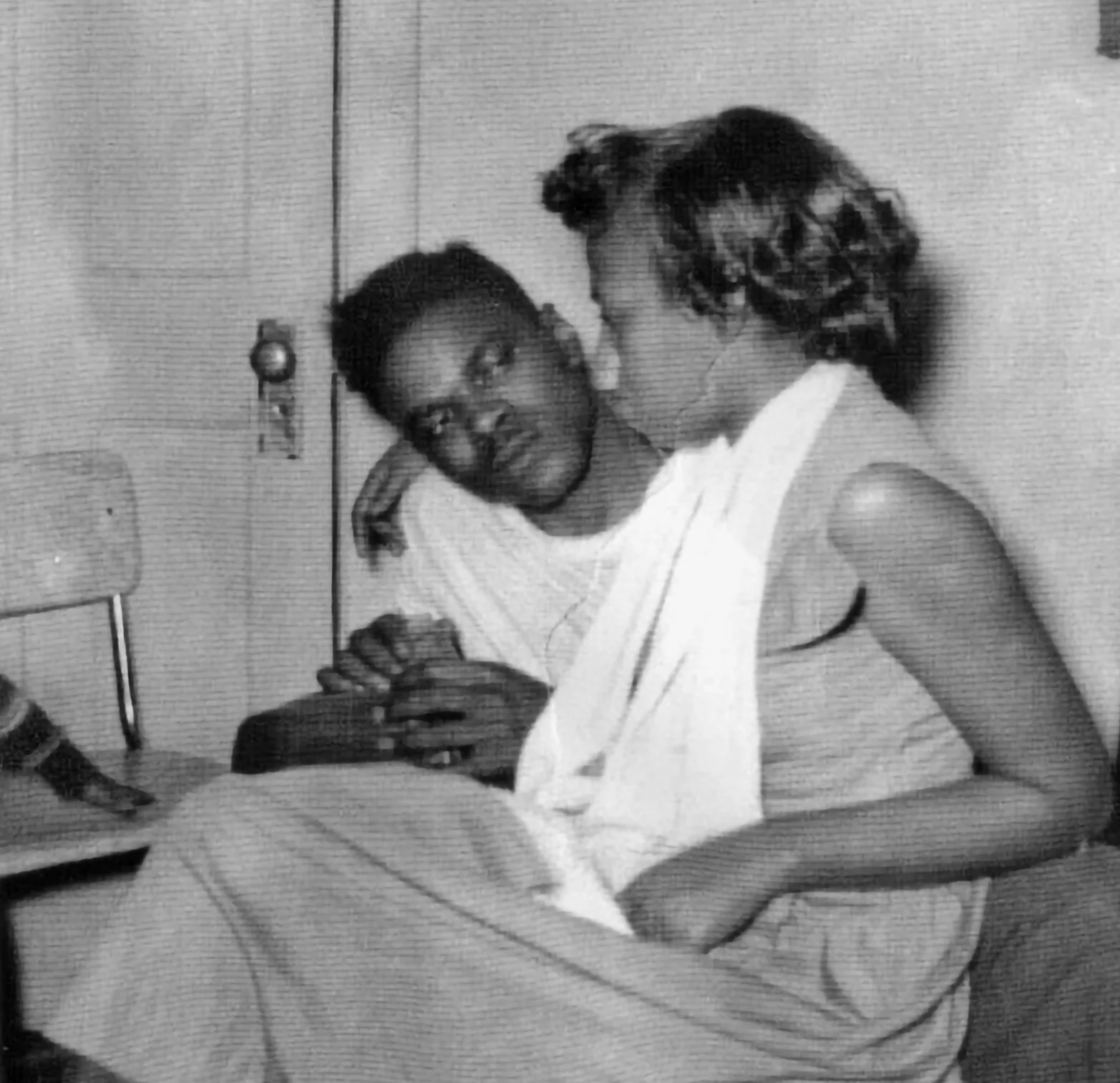 Low-quality black-and-white photocopy of a seated couple.